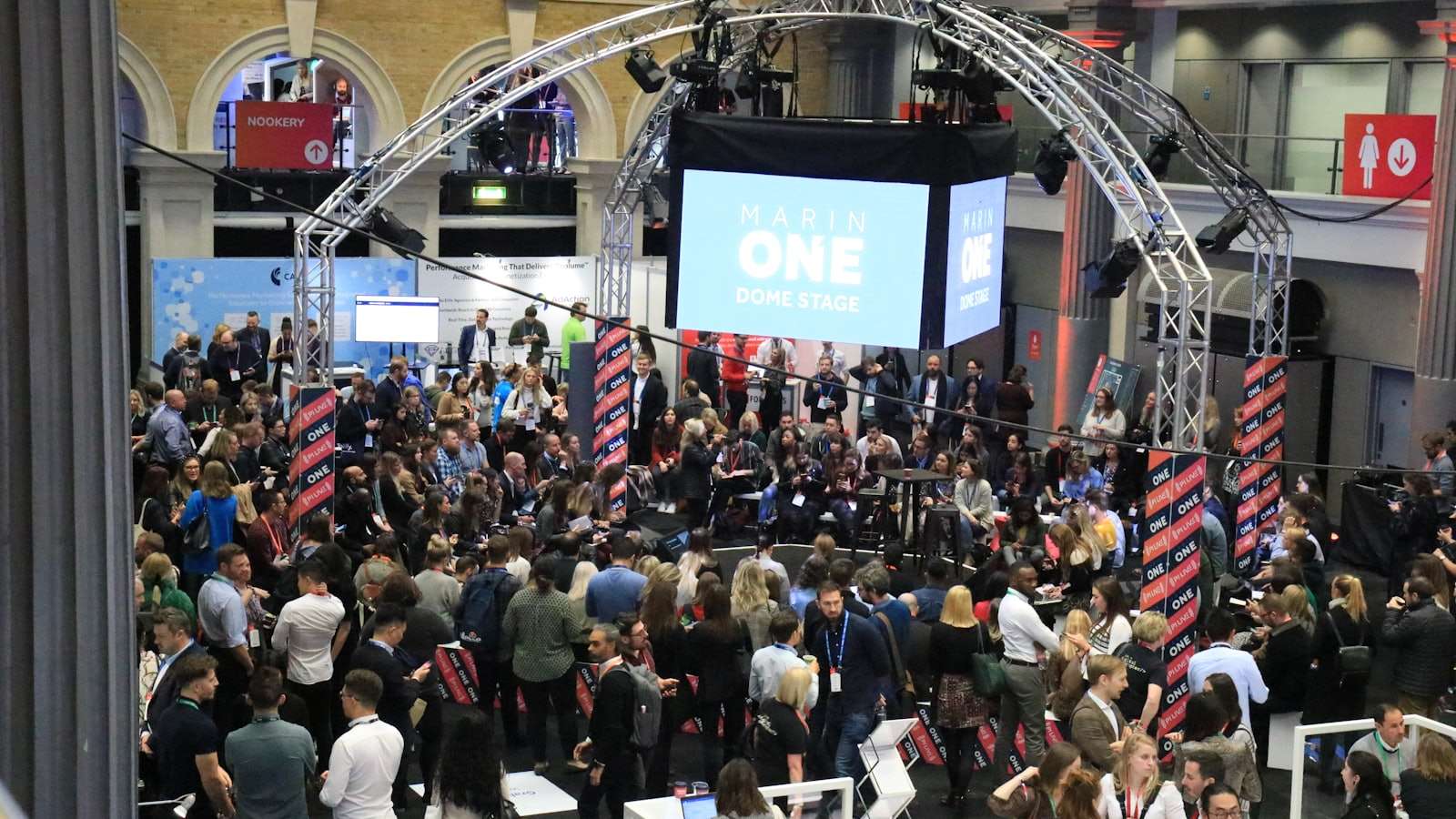 Audience at a corporate conference watching a large presentation screen