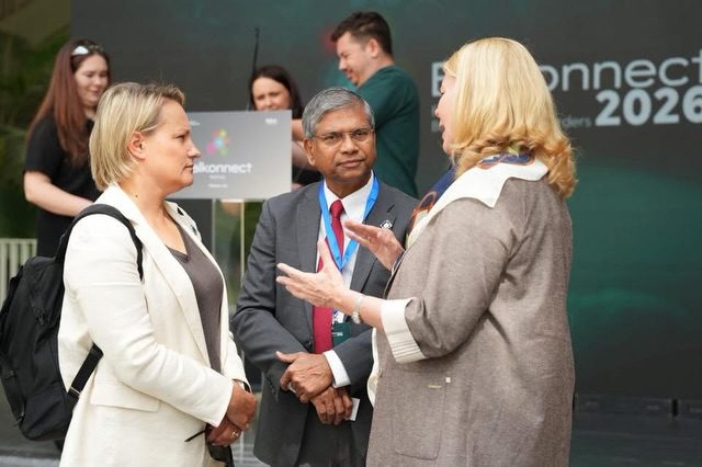 Delegates networking in front of the branded backdrop at Balkonnect Festival 2026, Tirana.