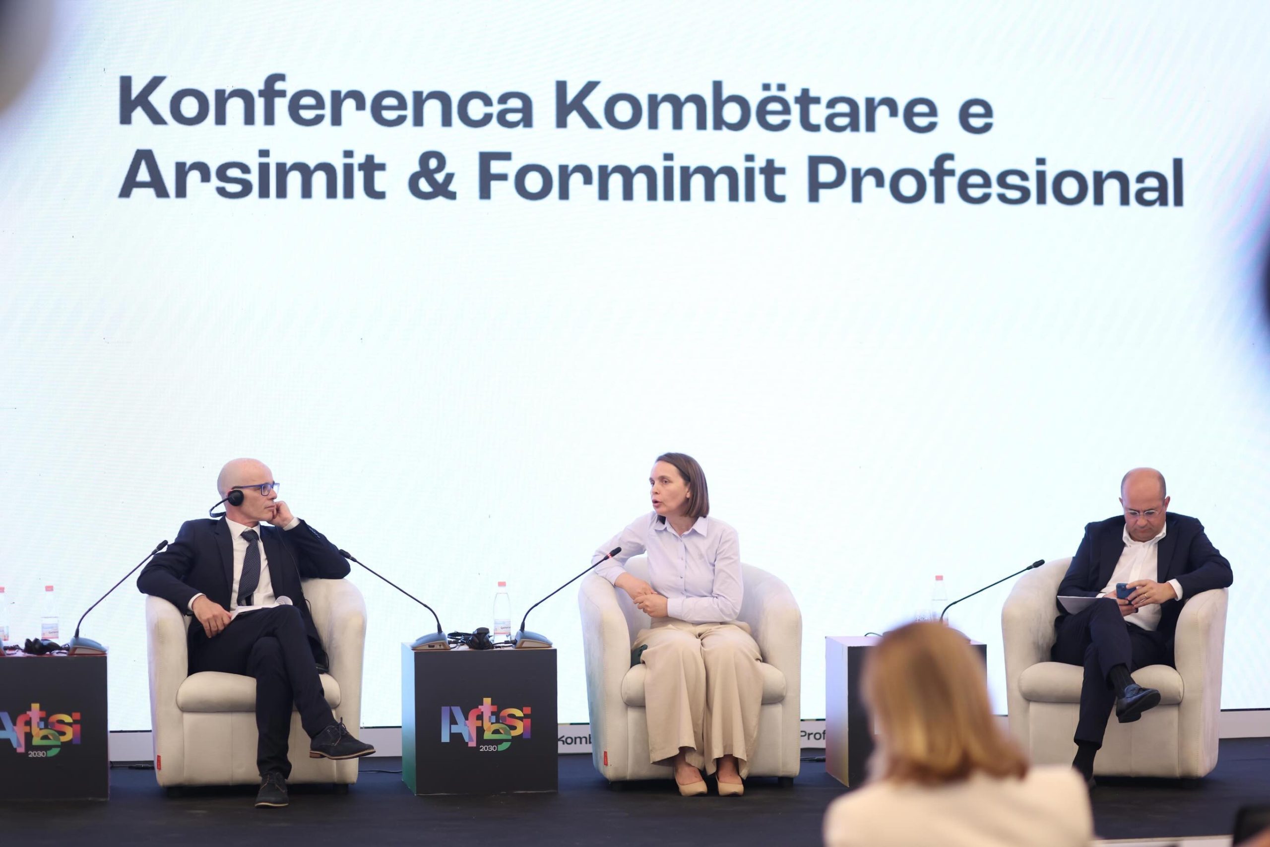 Panelists discussing vocational education on stage with LED backdrop at the National Vocational Education and Training Conference 2026 — event management by Overview DMC