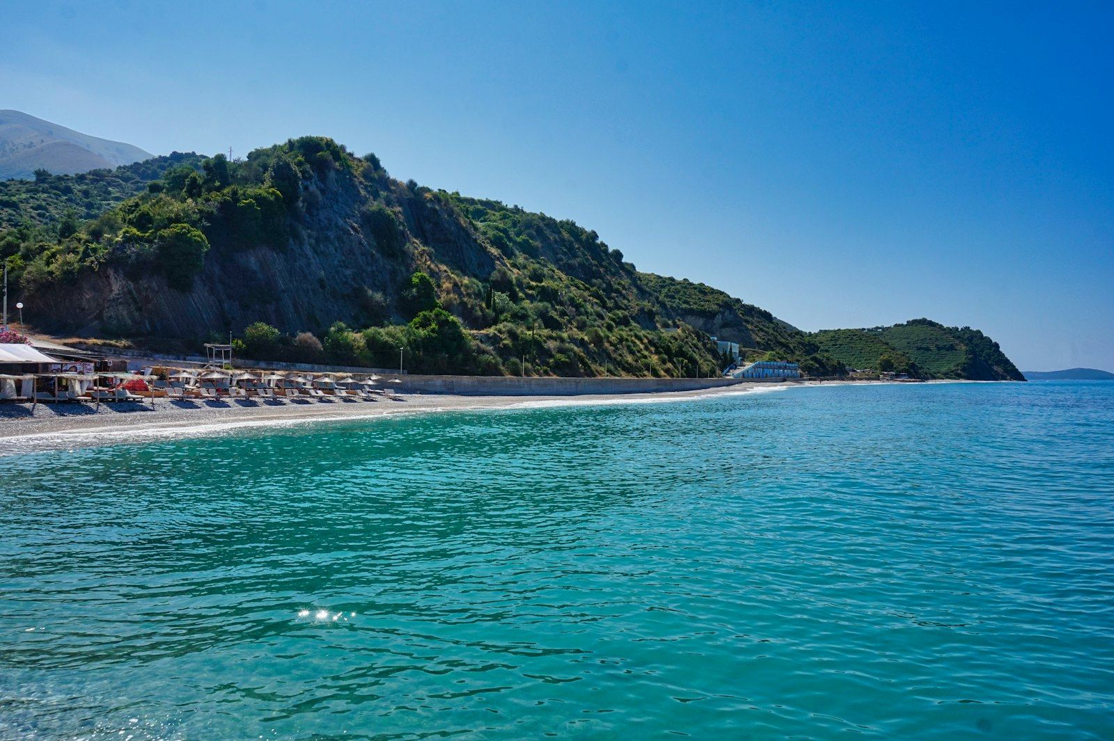A cove on the Albanian Riviera near Dhermi where the mountains drop into the Ionian Sea, a coastal corporate retreat setting