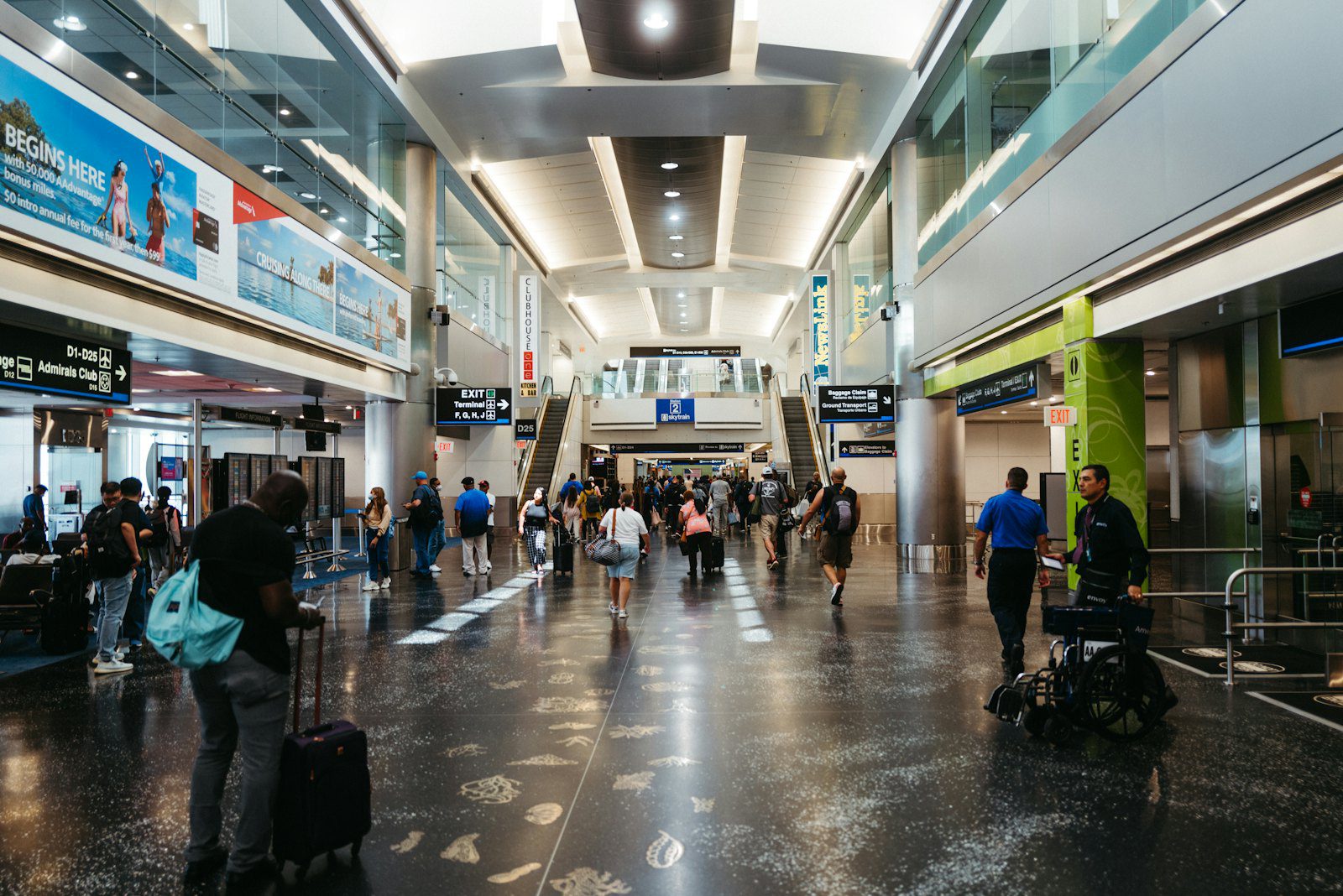 A group of passengers walking through airport arrivals toward passport control