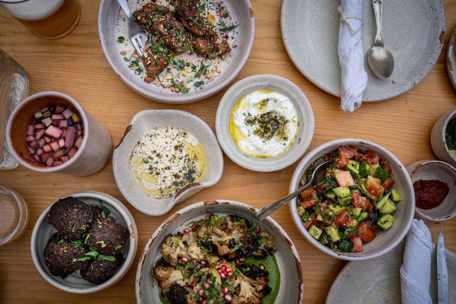 Table of traditional Albanian dishes including byrek, stuffed peppers and mezze plates for an event dinner