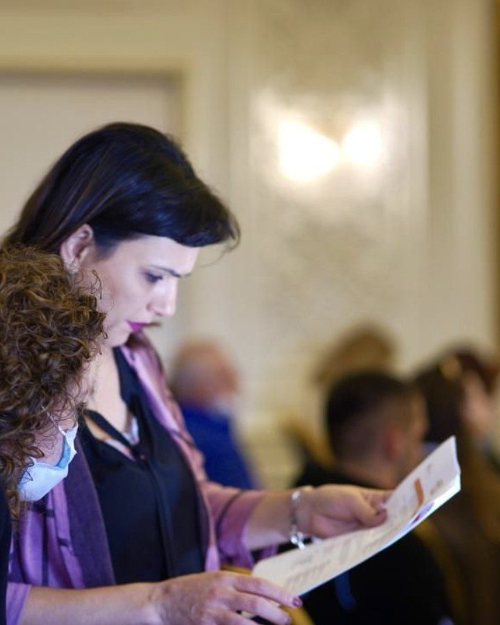 Brunilda Londo, Founder and Managing Director of Overview DMC, reviewing a run sheet on site at a conference in Tirana