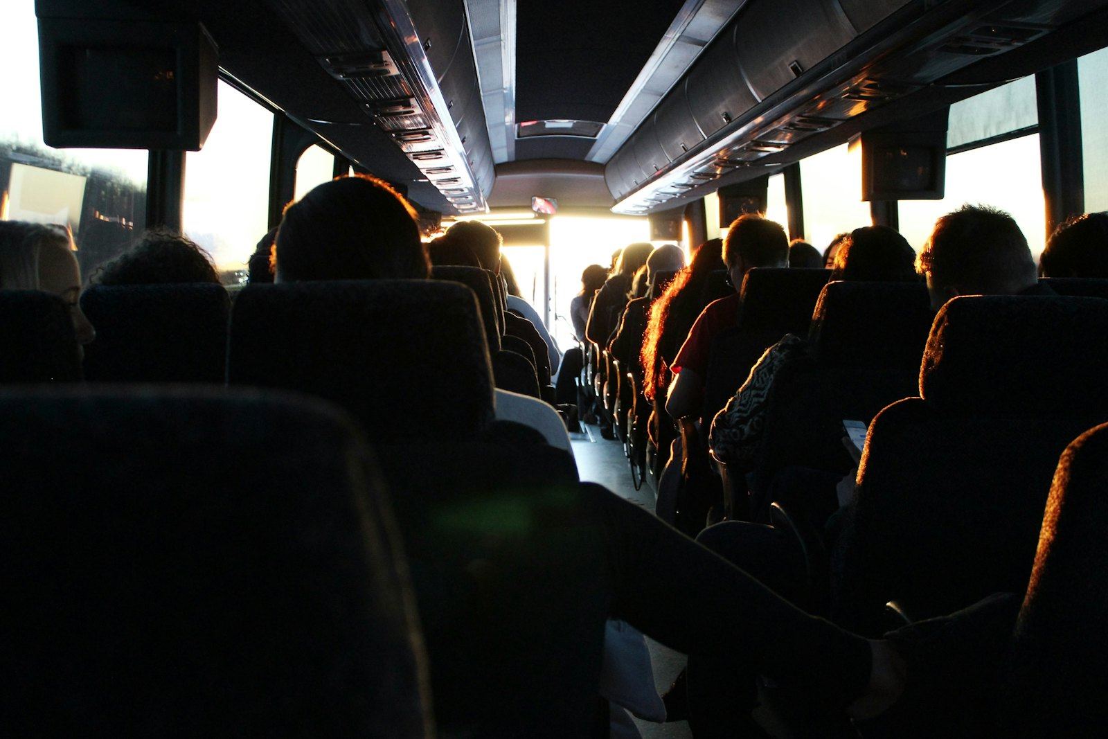 Delegates boarding a coach for a group transfer, the logistics leg where relocated event programmes lose margin