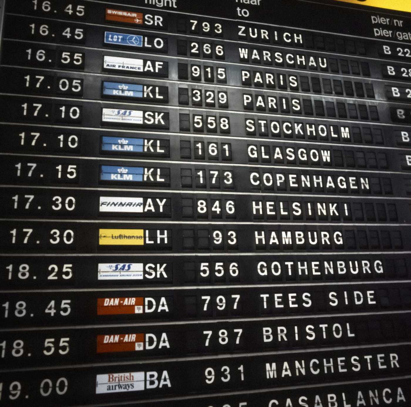 Airport departure board listing multiple flight destinations, illustrating route redundancy for event planners