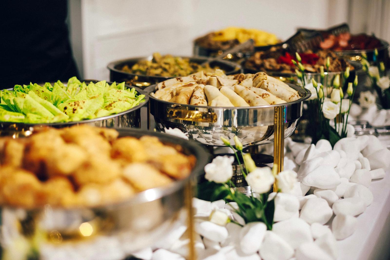 Hotel banquet buffet line with stainless chafing dishes set for a corporate lunch service